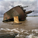 LIBERIA. Greenville. September 2005. A fisherman passes the wreck of an old ship off port of Greenville. Liberia is scattered with boat wrecks owing to the 14 year civil war.